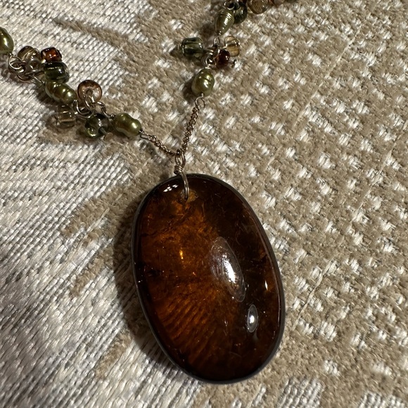 Beautiful amber stone hangs from chain with delicate clusters of small beads. - Picture 4 of 13